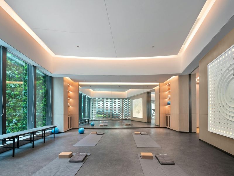 Modern minimalist exercise studio with dark walls and soft light